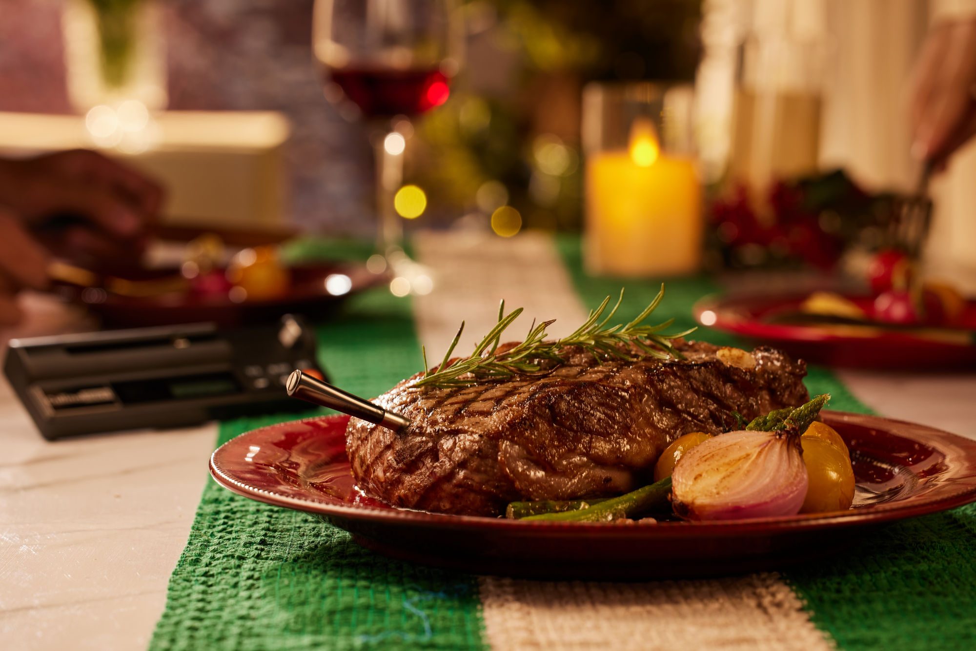 Steak on a plate with a blurred background of a festive table setting.